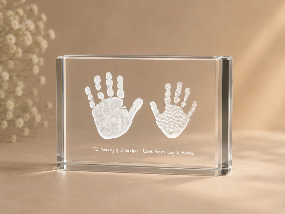 Handprints and a personal message engraved inside a crystal block