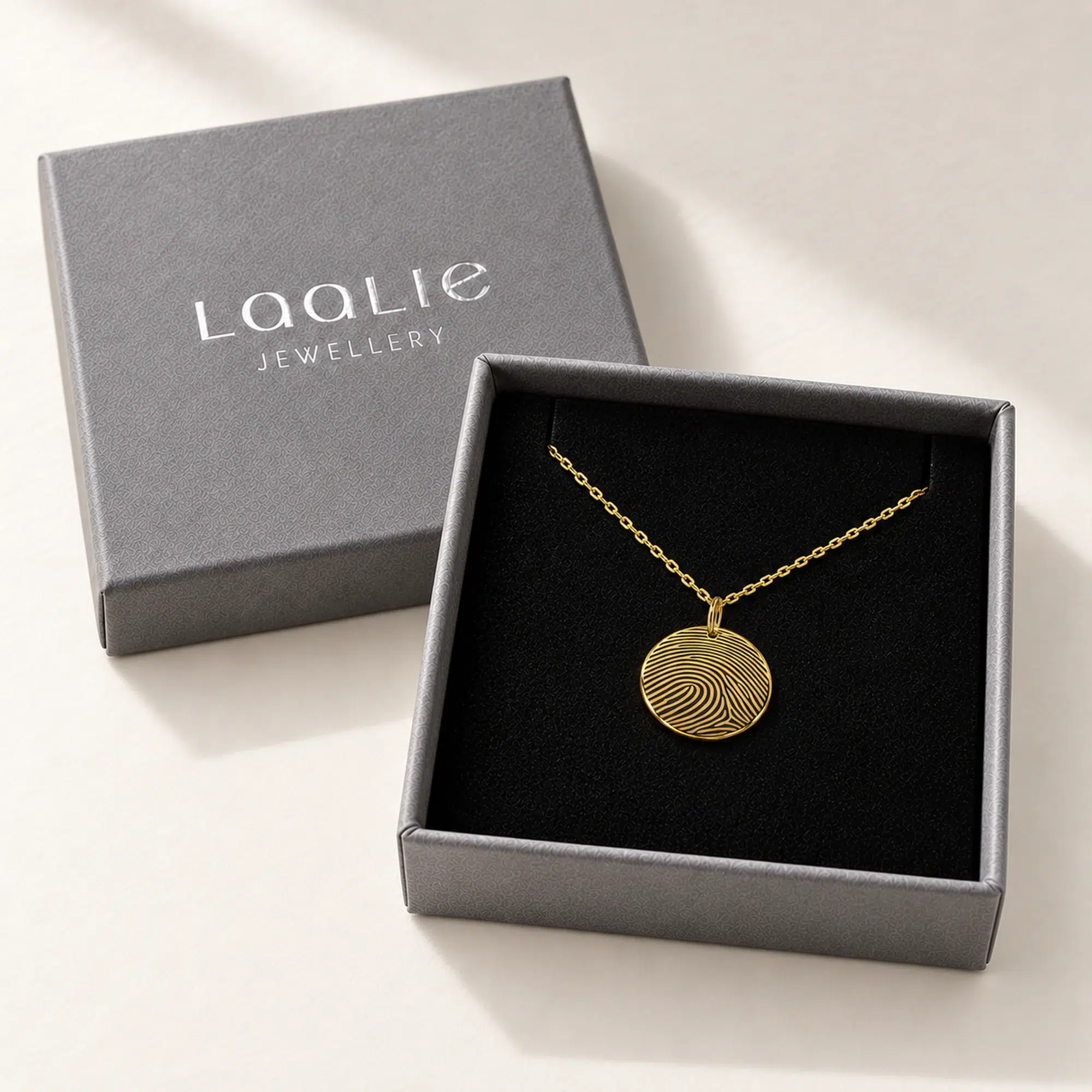 15mm gold coloured stainless steel fingerprint disc necklace in an open grey Laalie gift box