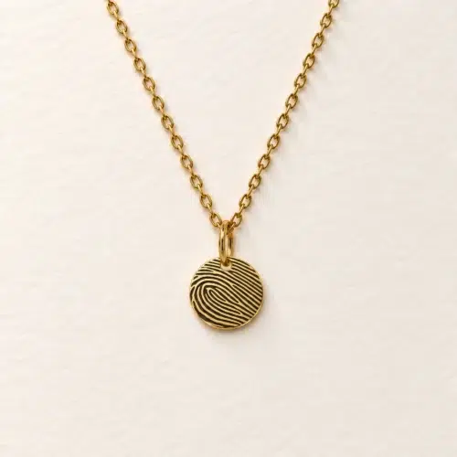 9mm gold coloured stainless steel disc necklace with fingerprint engraving on an ivory background