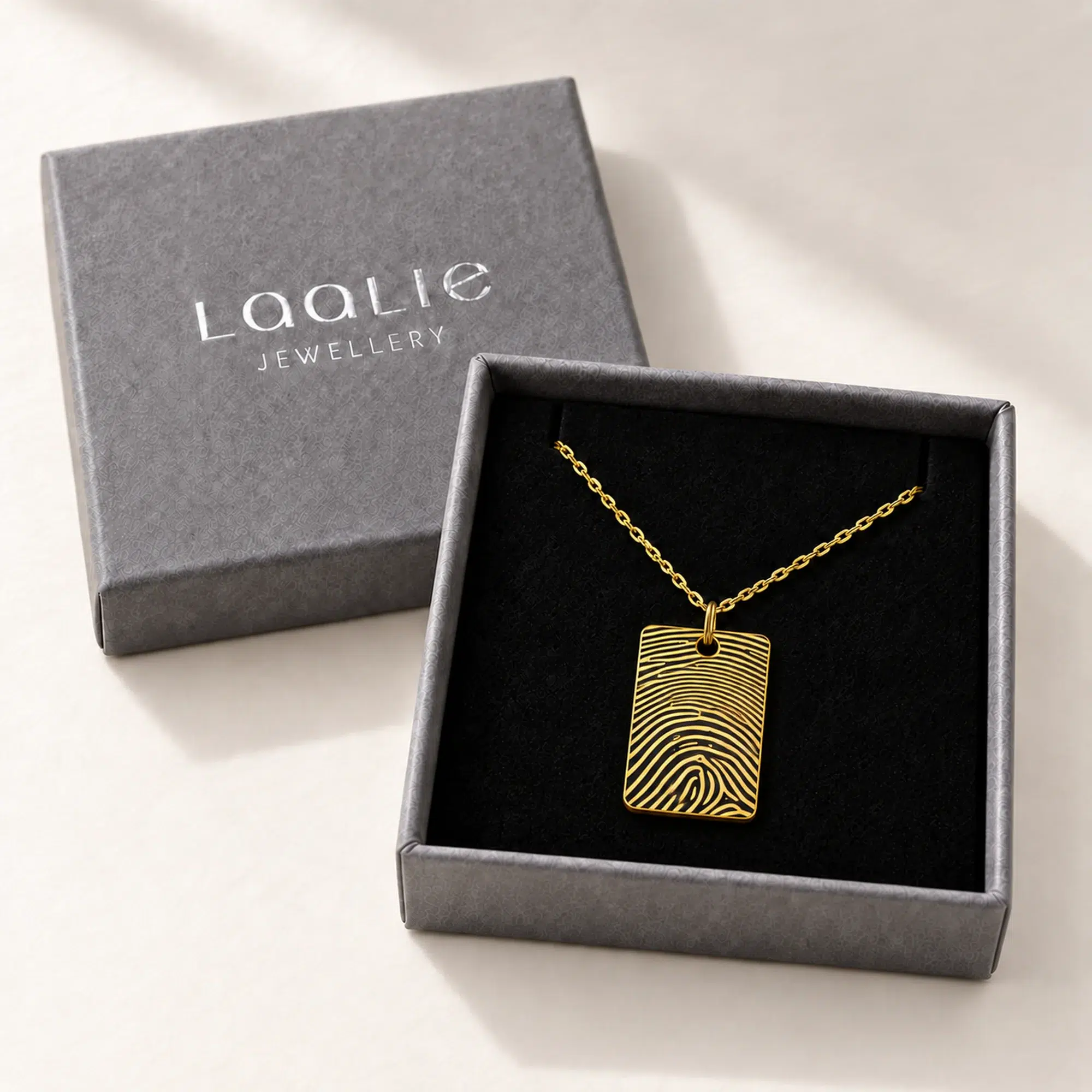 15 × 22mm gold coloured stainless steel fingerprint rectangle necklace in an open grey Laalie gift box