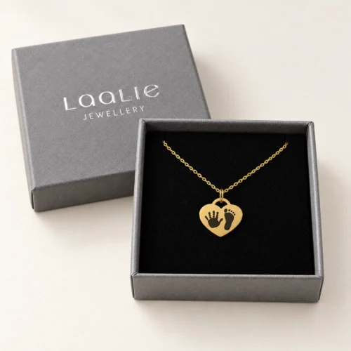 15mm gold coloured stainless steel heart necklace with a handprint and a footprint, in a Laalie gift box.