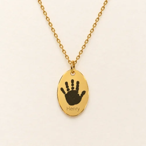 12x18mm gold coloured stainless steel oval necklace with a handprint.