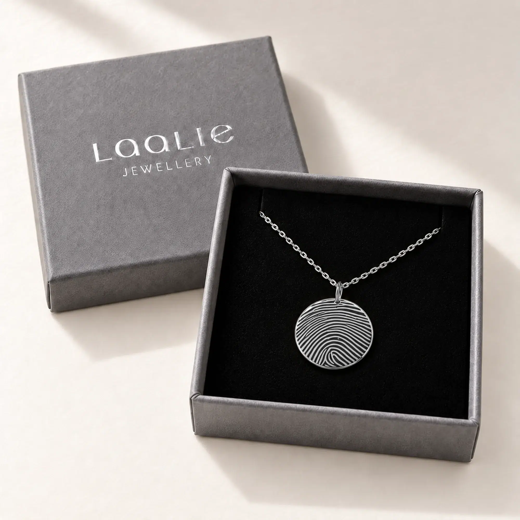 18mm silver coloured stainless steel fingerprint disc necklace in an open grey Laalie gift box