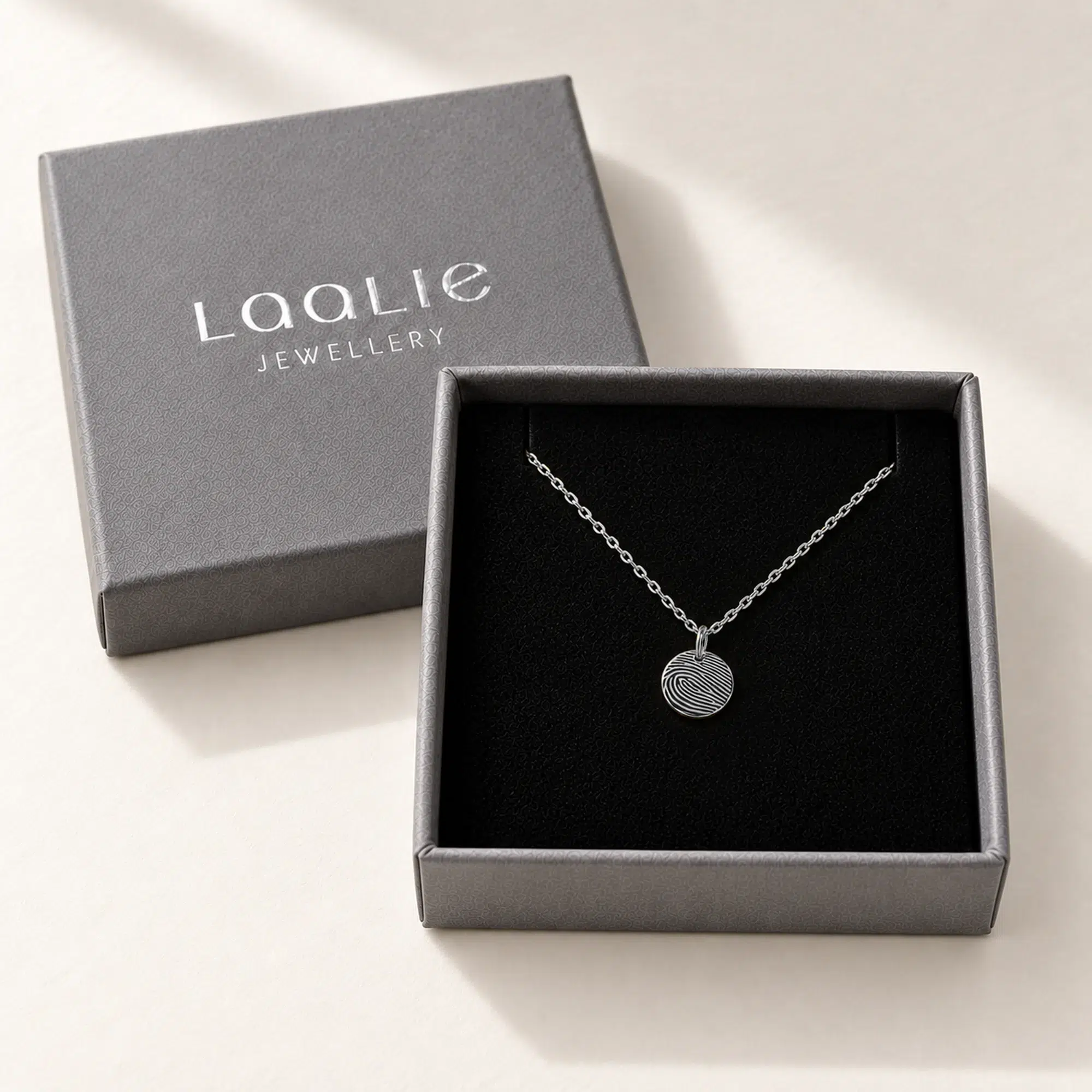 9mm silver coloured stainless steel fingerprint disc necklace in an open grey Laalie gift box