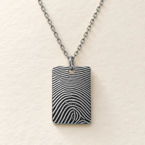 15 × 22mm silver coloured stainless steel rectangular pendant with fingerprint engraving on an ivory background