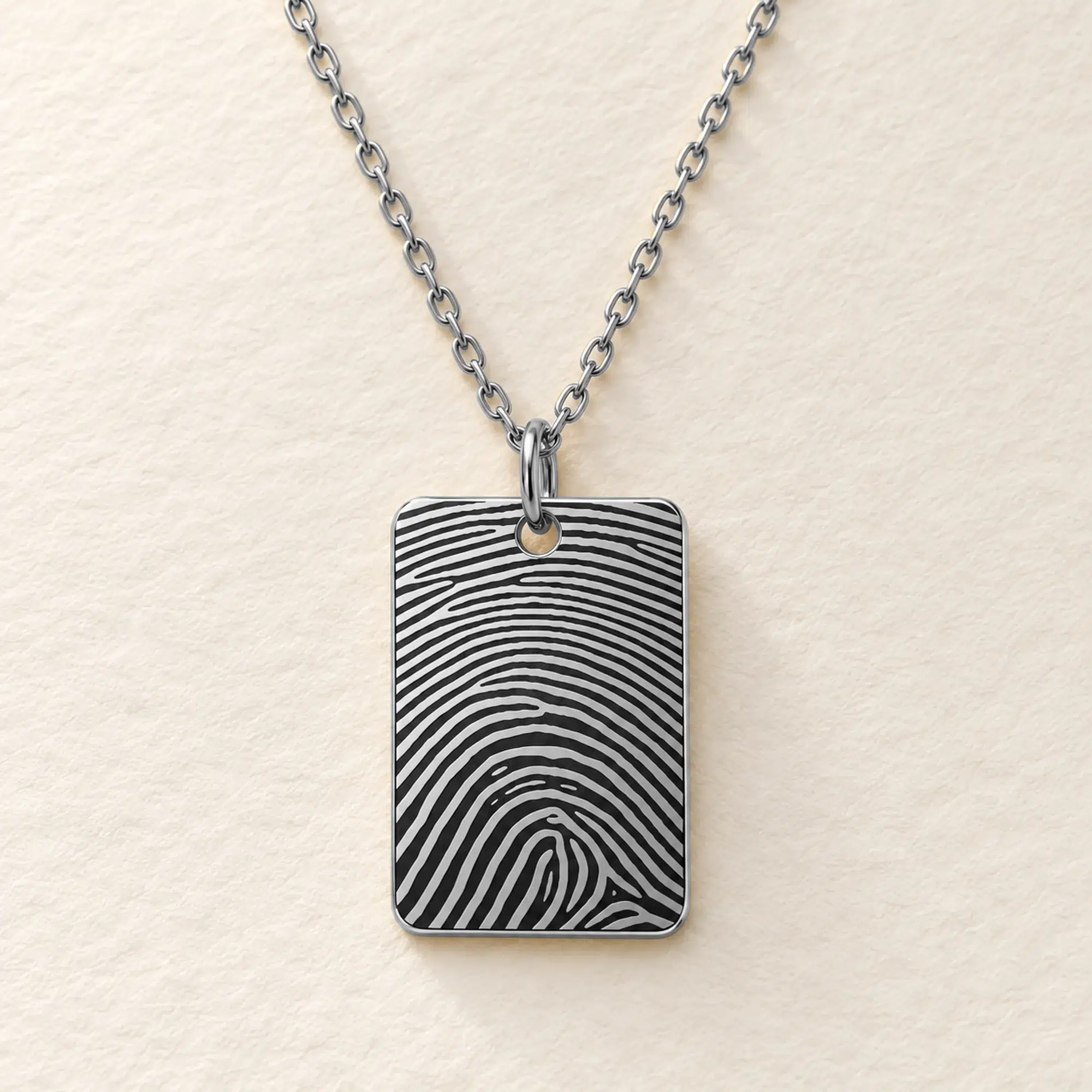 15 × 22mm silver coloured stainless steel rectangular pendant with fingerprint engraving on an ivory background