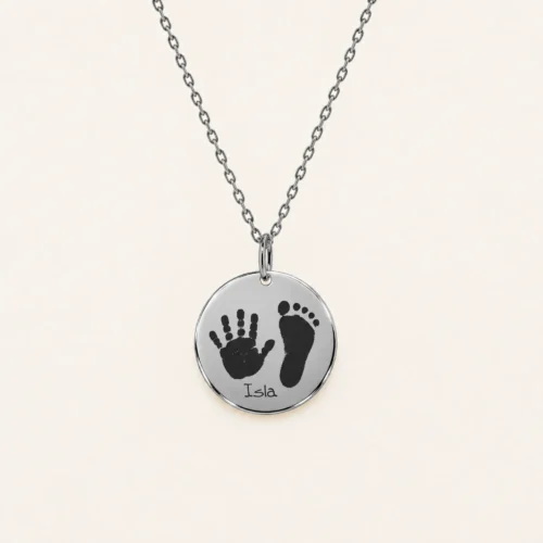 15mm silver coloured stainless steel disc necklace with a handprint and footprint.