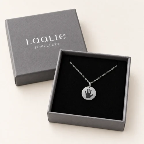 13mm silver coloured stainless steel disc necklace with a single handprint, in a Laalie gift box.