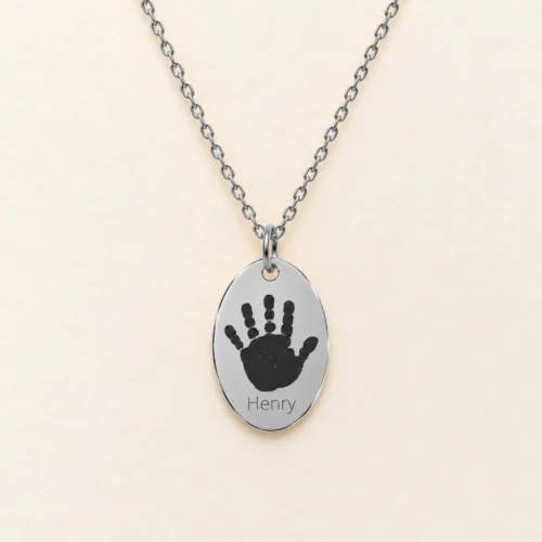 12x18mm silver coloured stainless steel oval necklace with a handprint.