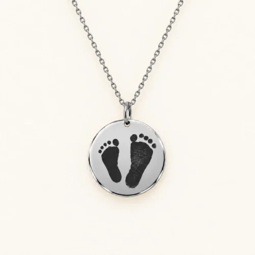 18mm silver coloured stainless steel disc necklace with a pair of footprints.